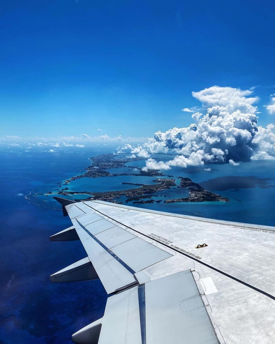 An aircraft wing over Bermuda on approach